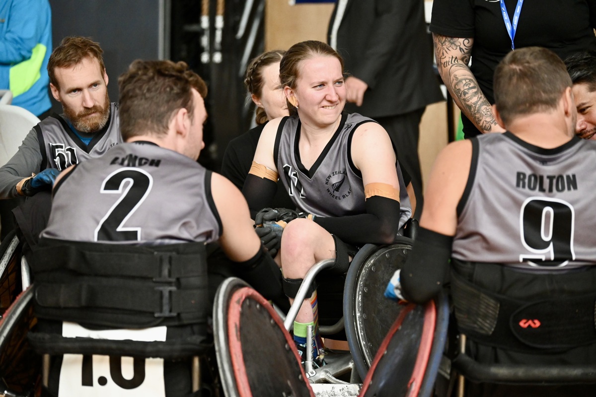 Jacinta Richardson sits in a wheelchair rugby chair among her teammates. 