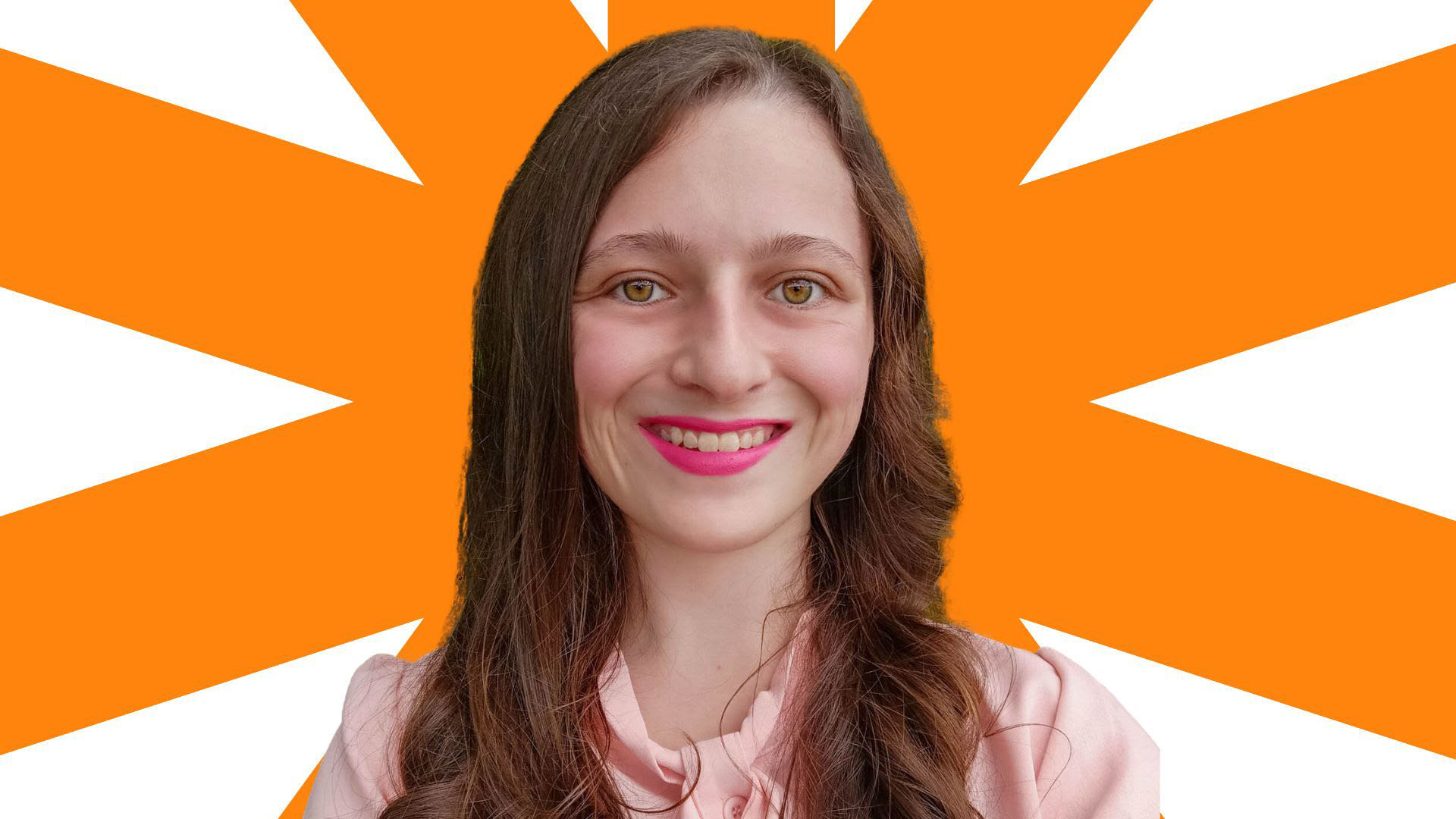 Image Description: Melissa, a woman with long brown hair, is facing the camera and smiling. She is wearing pink lipstick and a peach-pink blouse.