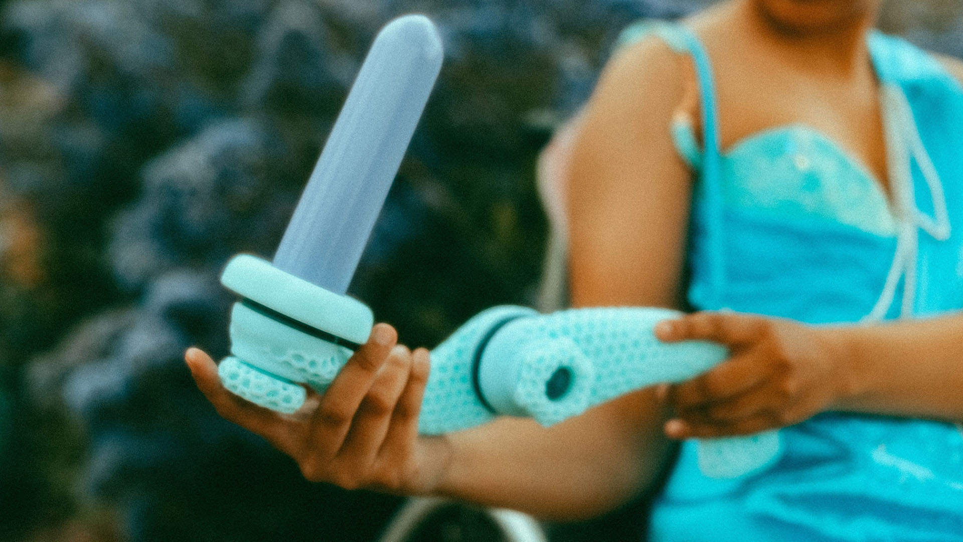 A blue-coloured adaptive reach extension system for a sex wellness toy.