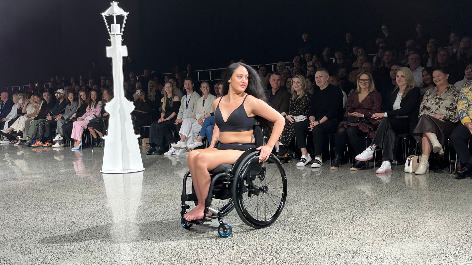 Chelsea is a wheelchair user and is wearing black underway on the runway