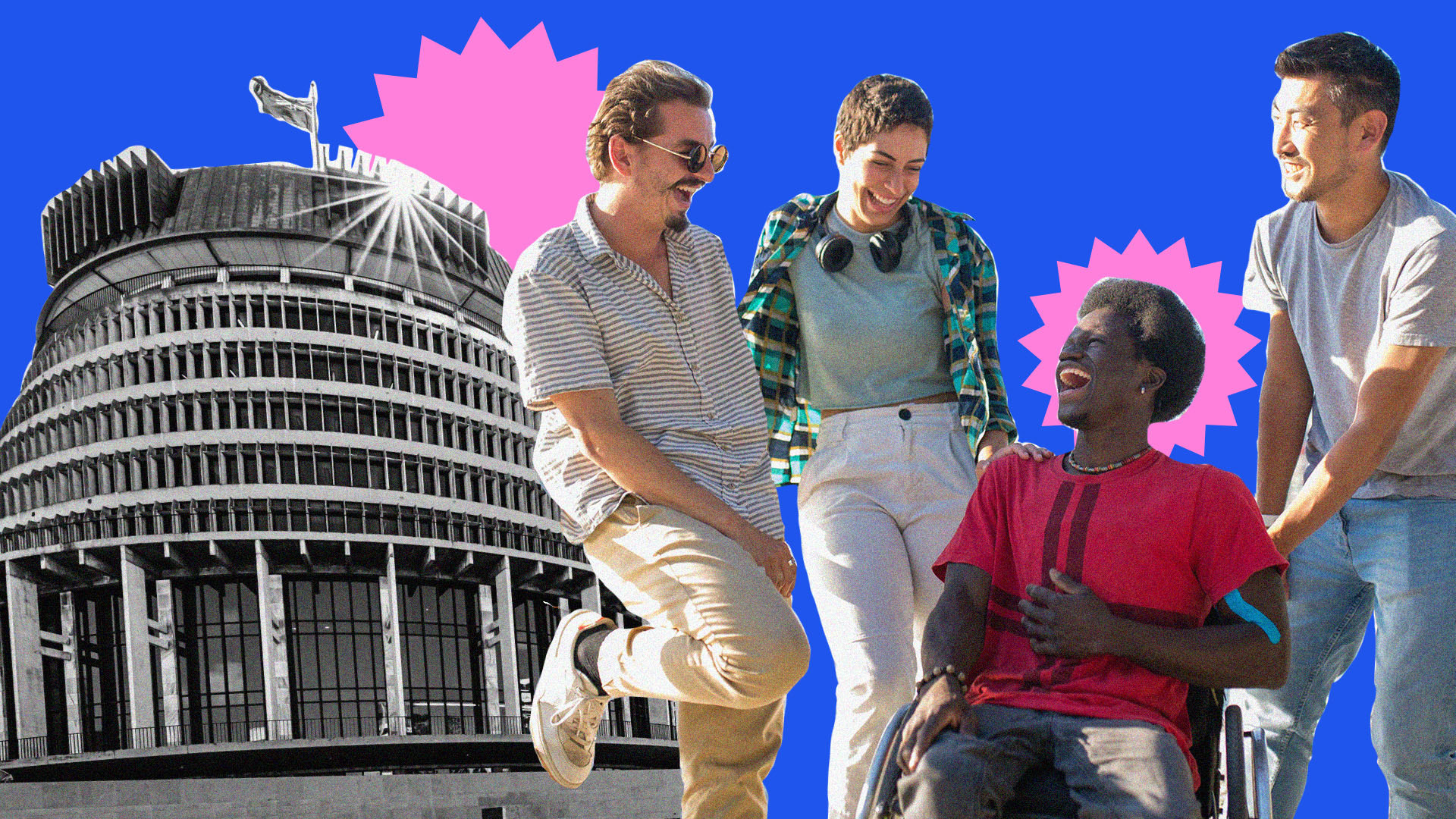 A group of people stand around a person sitting in a wheelchair, laughing. The NZ parliament building is visible in the background. 
