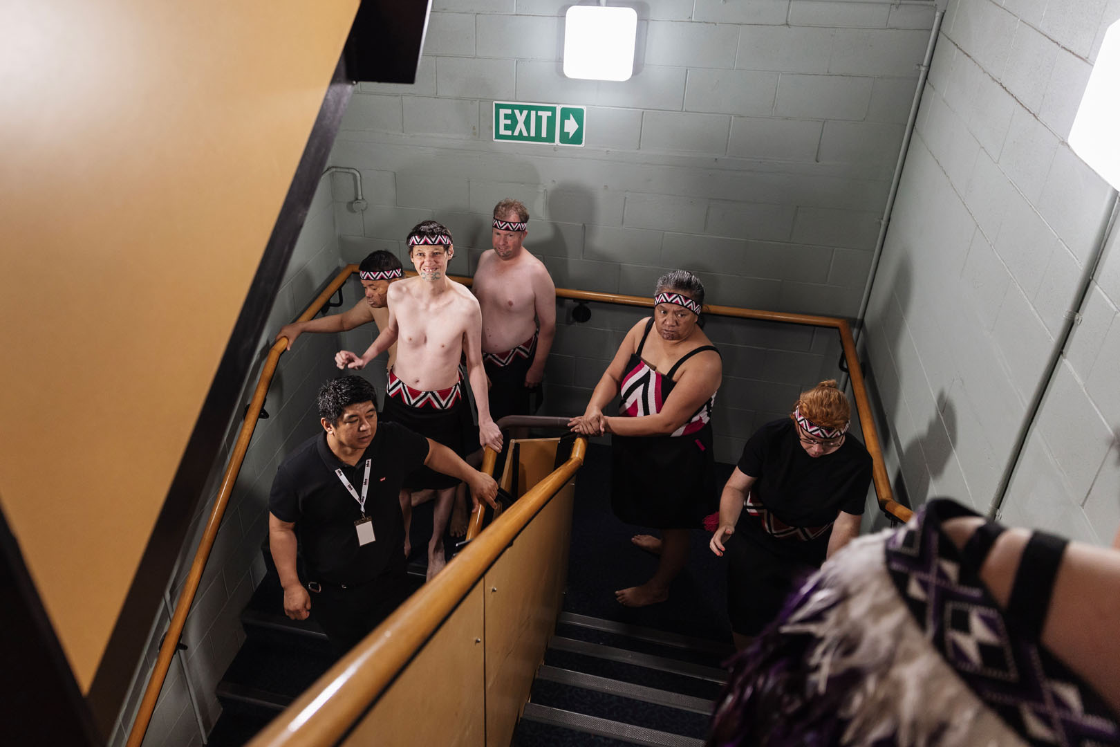 The kaihaka of Te Rōpu o te Hauāuru o Tāmaki walk downstairs.