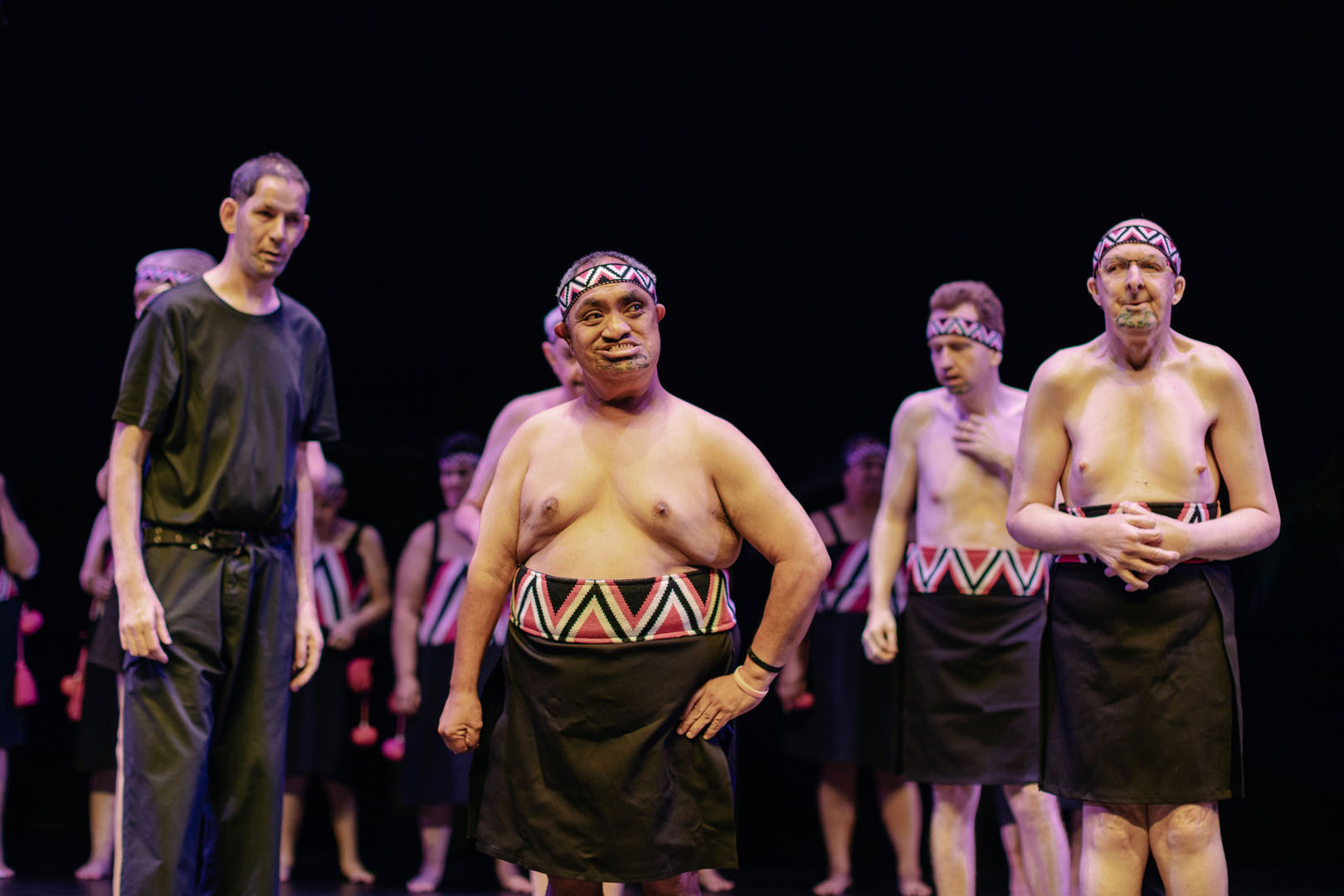 A kaihaka poses on stage; he looks proud of his performance.