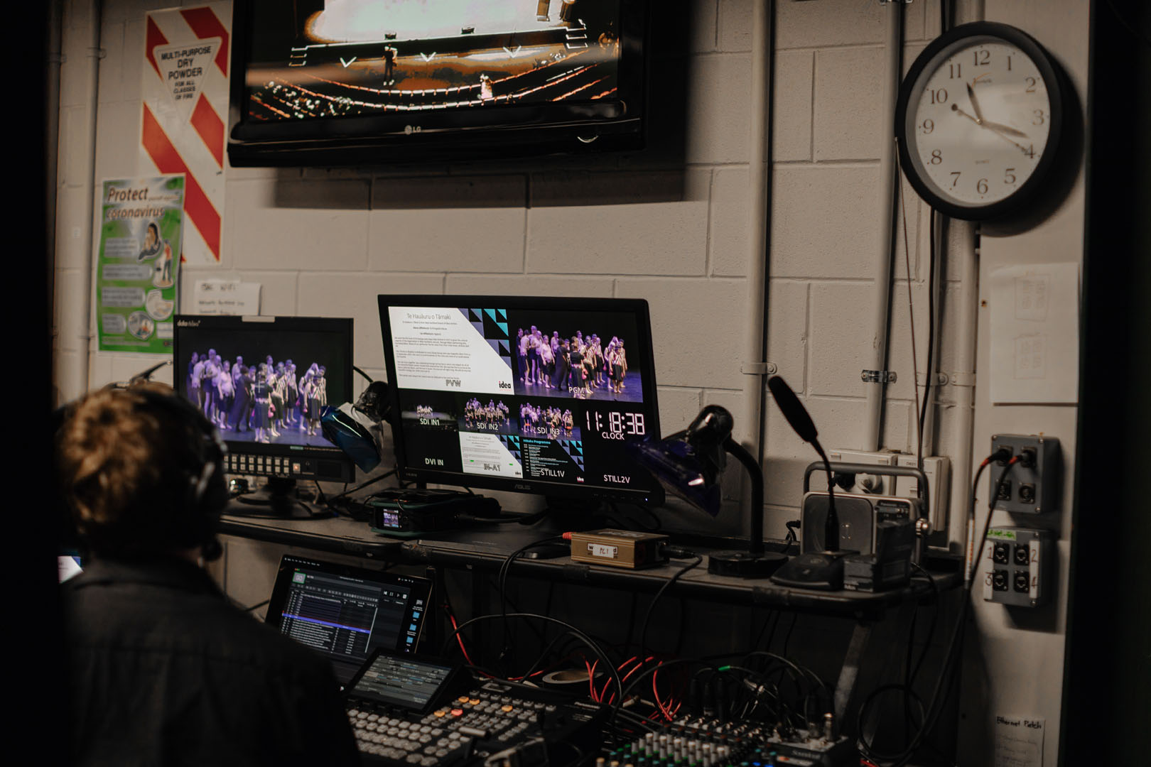 Backstage of Te Hoenga Waka Kapa Haka Festival shows a screen with performers on stage. 