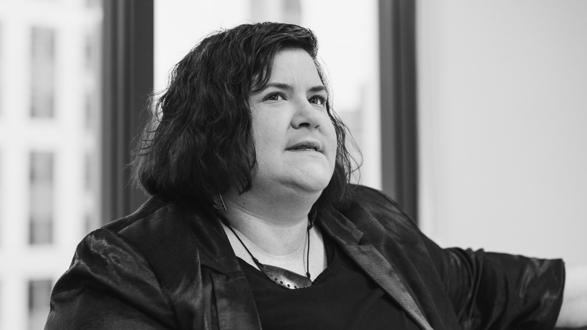 A black and white photo of Prudence Walker. She looks contemplative, away from from the camera. 