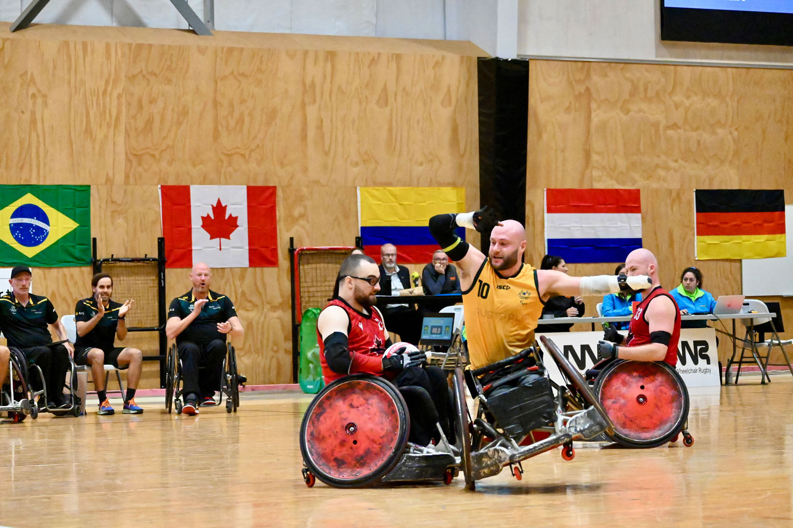 An Australian wheelchair rugby player crashes into a Canadian athlete and tips in his chair on one wheel.