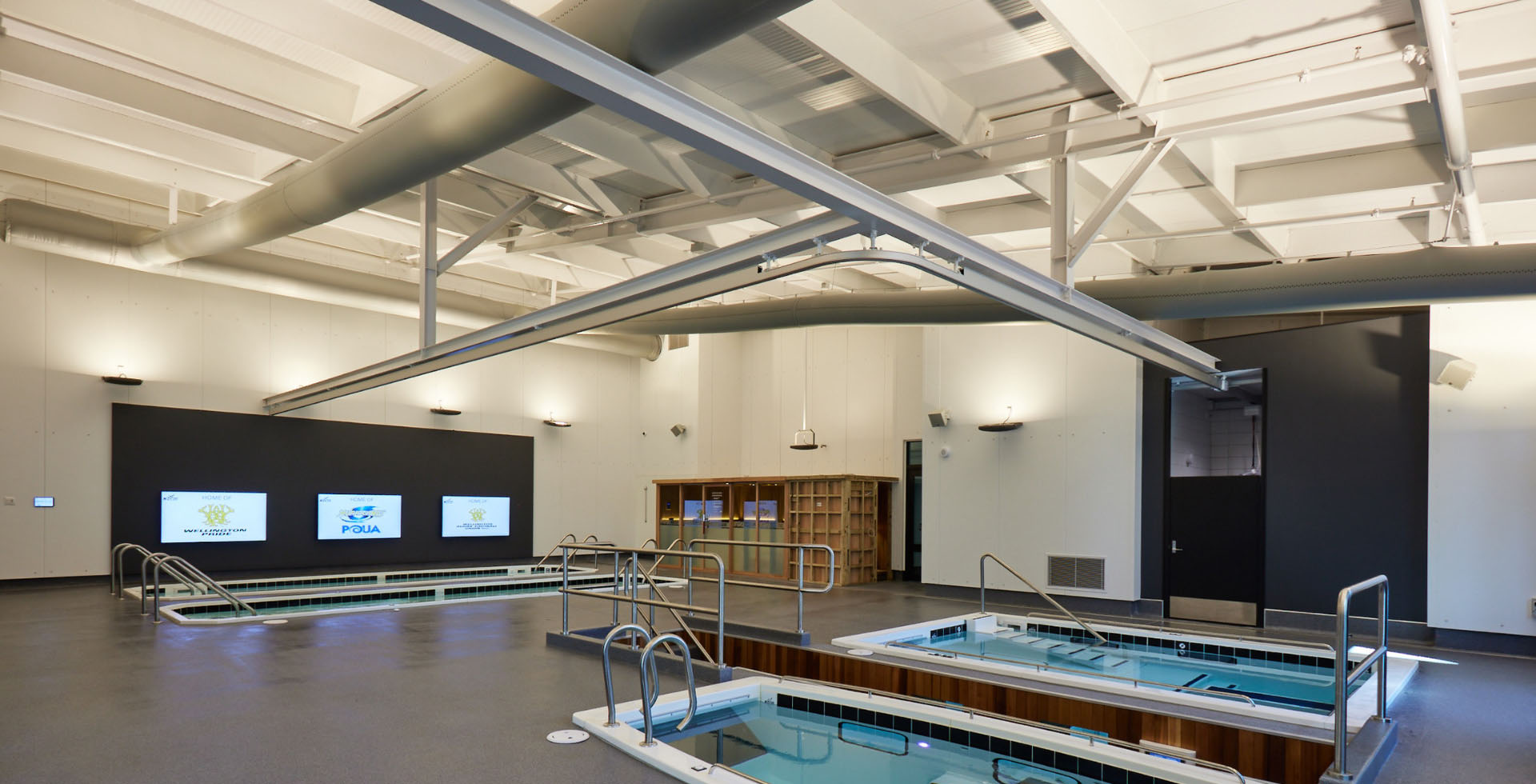 A T-shaped rail overhead reaches over four small recovery pools in NZCIS’ pool room. 