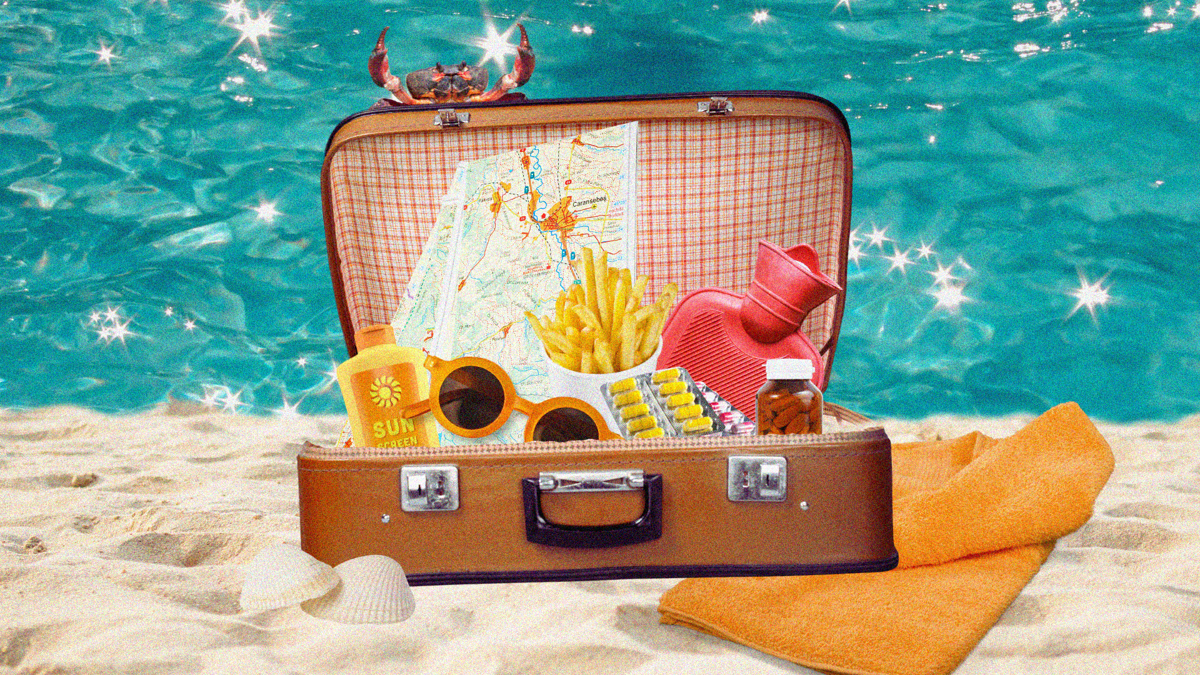 A vintage suitcase is filled with sunblock, sunglasses, a map, hot chips, medicine and a red hot water bottle. The background is a sandy beach with sparkling water.