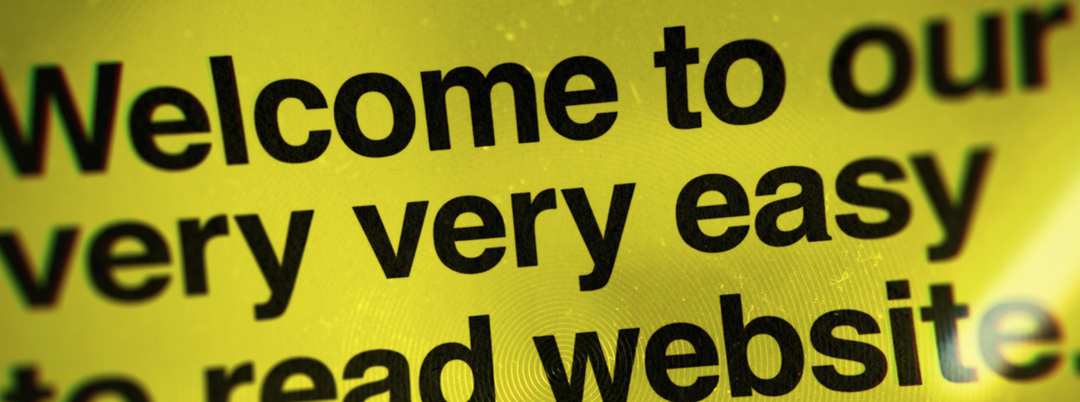 Image description: A screenshot from Blind Low Vision's website states, 'Welcome to our very, very easy to read website'. The text is black against a yellow background 
