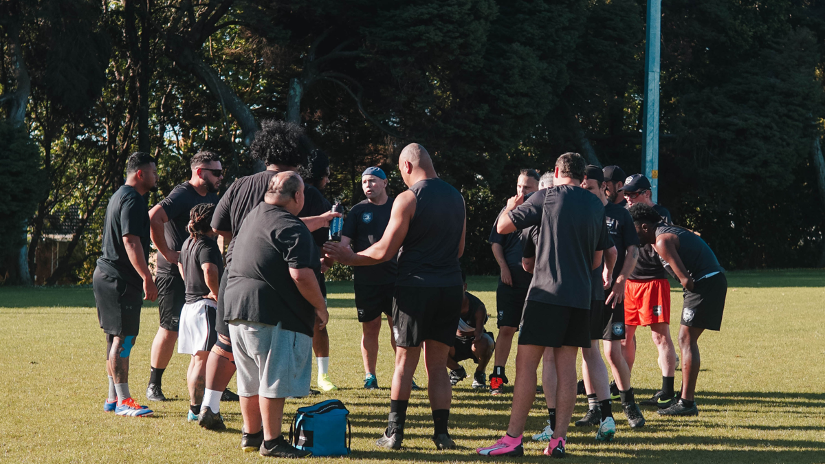 Photo of the Whaikaha Kiwis in a team huddle 