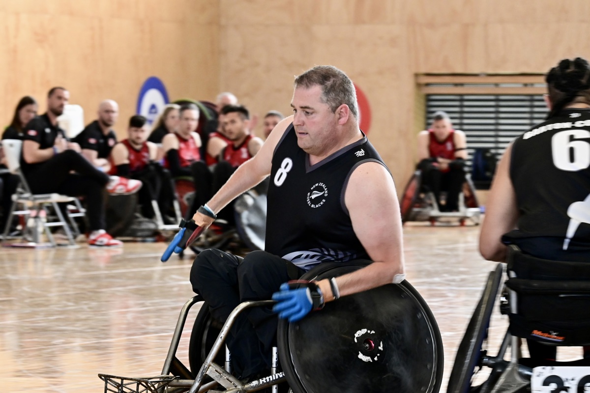 Mike Todd is playing wheelchair rugby; his face is concentrating on where he is moving to at speed.