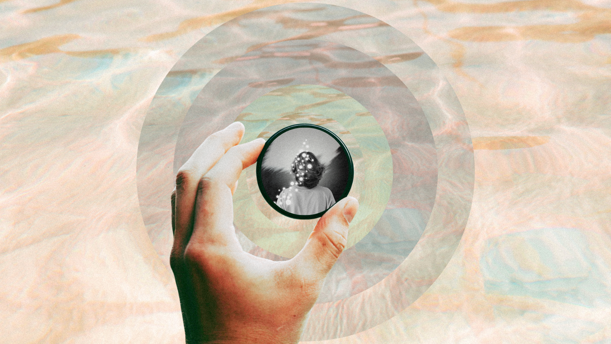 Layers of grey circles are seen through reflective water. Over that, a hand holds a mirror with an image of an adolescent's back with light shining through.