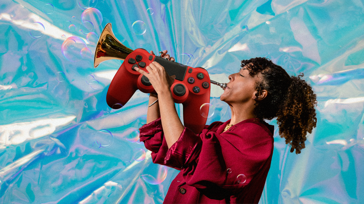 A woman blows a trumpet in the shape of a PlayStation controller. There are bubbles and a plastic, shiny material surrounding her.