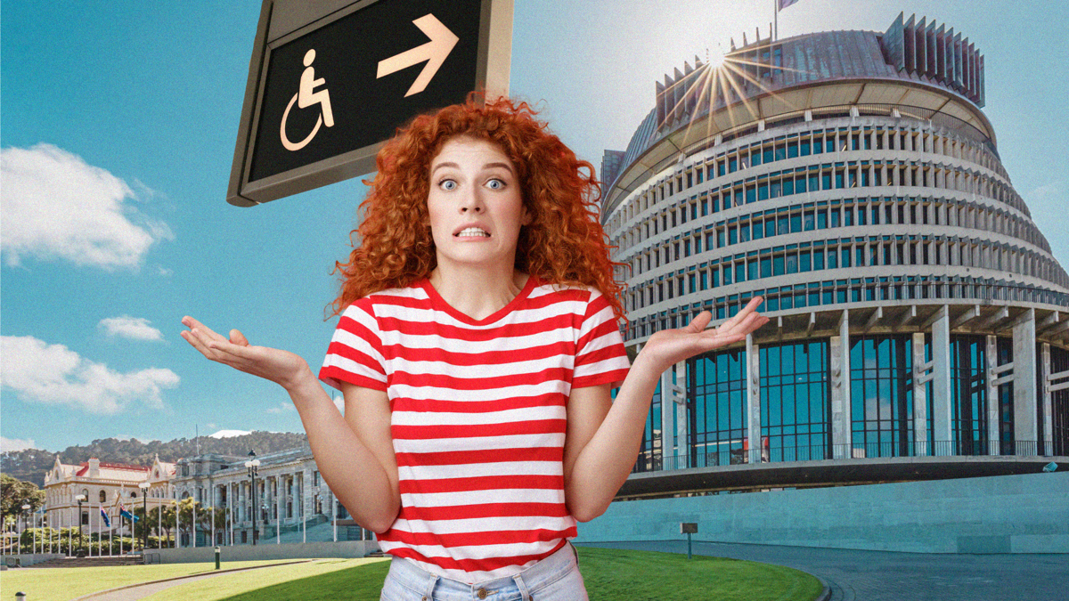 A woman with red curly hair wearing a red and white t-shirt shrugs and looks confused. In the background is a wheelchair sign and Aotearoa's Parliament building.