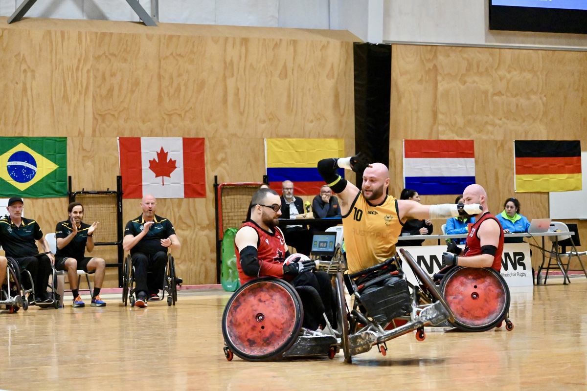 An Australian wheelchair rugby player crashes into a Canadian athlete and tips in his chair on one wheel.